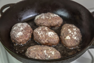 Homemade cutlets of meat during cooking in the pan
