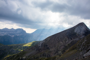 Fototapeta premium Mountain landscape with storm clouds and sunshine