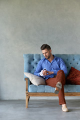 Sexy man model siting on the vintage sofa