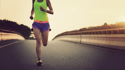 Fototapeta na wymiar young fitness asian woman runner running on city road