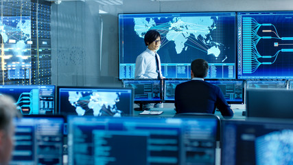 In the System Control Room Chief Engineer Holds a Briefing for Member of the Staff. They're Work in...