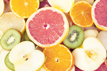 Fototapeta na wymiar Grapefruit texture. Fruits as background texture pattern. lemon,orange kiwi citrus fruits half fruit wallpaper. Yellow orange,pink,green.