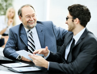 The image of business partners discussing documents and ideas the office