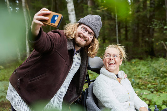 Couple taking selfies in forest