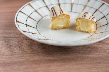 two halves of eclair on porcelain plate