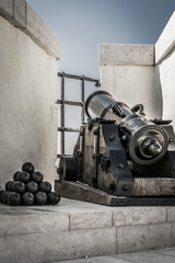 Fototapeta na wymiar Mediaval cannon with the cannon balls