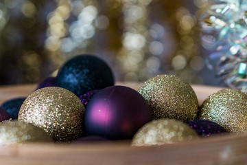 Close-up of Christmas decoration brocade balls whith golden bokeh background. Concept Christmas.Shallow dept of field.