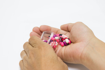  The many pill and capsules in hand man -  isolated white background