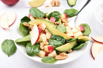 Fruit salad from apples, avocado, spinach and nuts