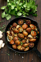 Delicious fried mushrooms in pan on wooden table, top view