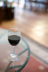 detail of glass with red wine on top a table