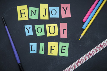 Enjoy your life inscription on a blackboard