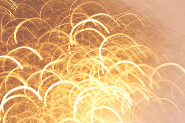 Beautiful defocused festive background in golden colors. Wallpaper, holiday design, blurred motion.