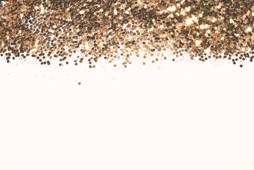 Textured background with golden glitter sparkle on white, decorative spangles in nostalgic colors