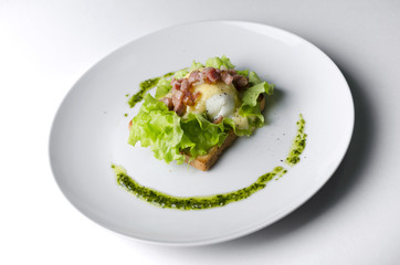 Sandwich with poached egg and bacon