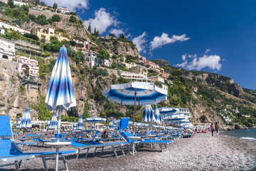 Positano, Italy - Beach with umbrellas, Amalfi coast, vacation concept