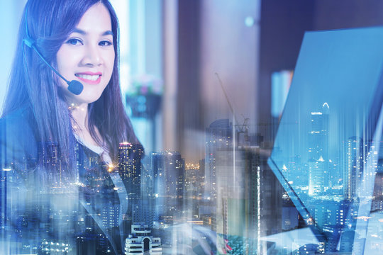 Smiling asian businesswoman using headset against elegane wooden interior room business ideas concept - Powered by Adobe