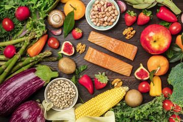 Overhead photo of fresh vegetables, legumes, fruits, and fish, healthy diet