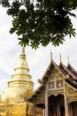 Traditional Thai style architecture public temple in North of Thailand, Wooden temple and gold pagoda