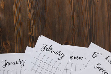 top view of paper calendar on wooden tabletop