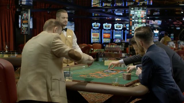 Men betting in a casino