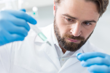 Serious bearded biologist conducting an analysis