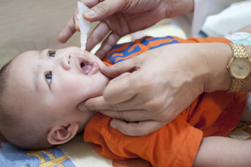 Oral vaccination of a baby boy - obrazy, fototapety, plakaty