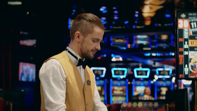 Dealer cleaning table in a casino