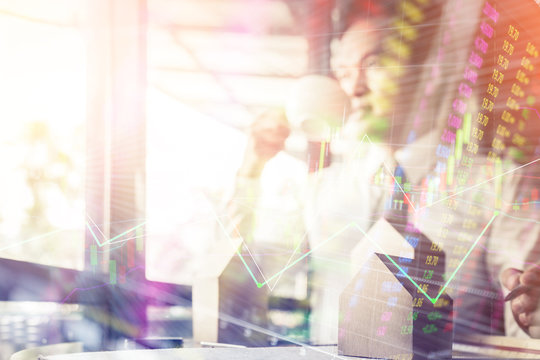 house home mortgage concept with business man hand with house model and sample of material on wooden desk