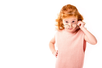 red hair kid looking above glasses isolated on white