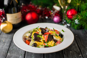 Serving the New Year's table for several people with a Christmas tree. Photos in the interior