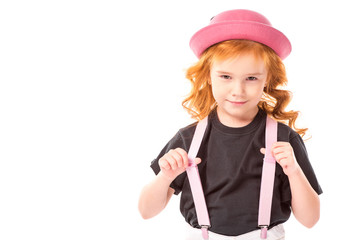 funny red hair kid holding pink suspenders isolated on white