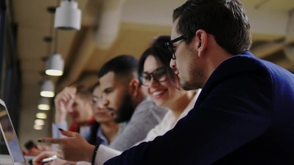 Young colleagues discussing ideas in coworking office