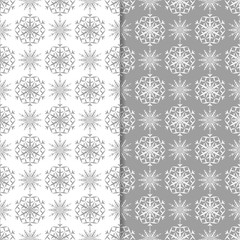 Snowflakes patterns. Set of gray seamless backgrounds with christmas elements