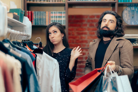 Funny Couple Arguing while Shopping in Clothes Store