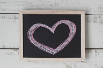 Handwritten heart on blackboard. Chalkboard with heart shaped drawing. Love concept