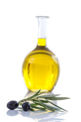 Corsican, traditional Olive oil glass bottle and olive branch on the table on a white vackground