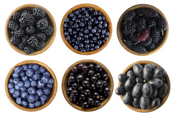 Black and blue berries on a white background. Blackberries, blackcurrants, blueberries, mulberries...