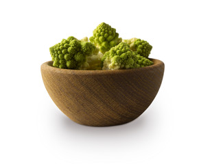 Roman cauliflower in wooden bowl isolated on white background. Roman cauliflower close up. Fractal texture of romanesco broccoli. Roman cauliflower with copy space for text.