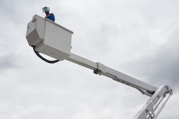 An electrician on aerial platform