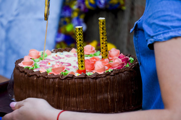 A festive cake with sparkling pyrotechnics stuck in it.
