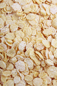 Corn flakes texture closeup pattern as background. Breakfast food photo. Cereals.