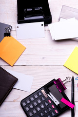 Business card with empty space and binders near sticky notes.