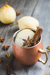 Cold Moscow Mule cocktail in copper mug on the rustic background. Shallow depth of field.