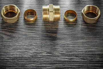 Threaded pipe fittings on vintage wooden board