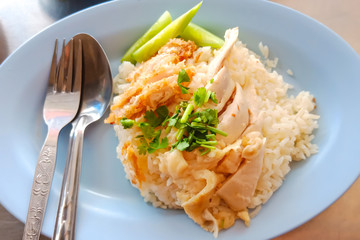 Seletive focus on vegetable of Thai traditional food (Khao-Mun-Kai). Chicken rice with Chicken fried crispy.