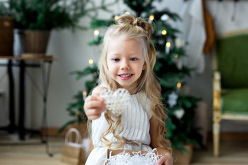 Happy cute little smiling girl with christmas gift box. Merry Christmas and Happy Holidays.