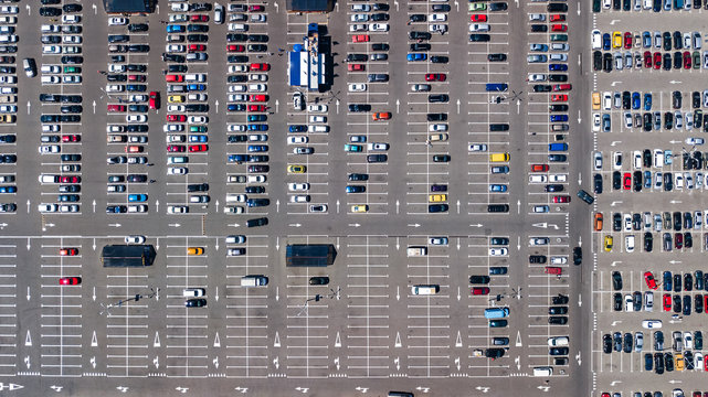 Aerial top view of parking lot with many cars from above, city transportation and urban concept
