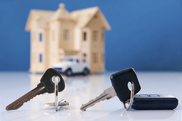 Car key and house keys with new automobile and home