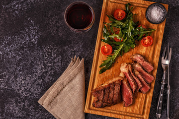 Beef steak on a dark background.